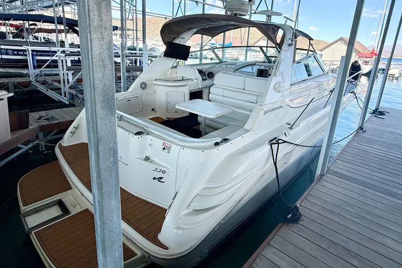 The Image of 1998 Sea Ray Sundancer 330 docked, showcasing sleek design and spacious deck area. - 0