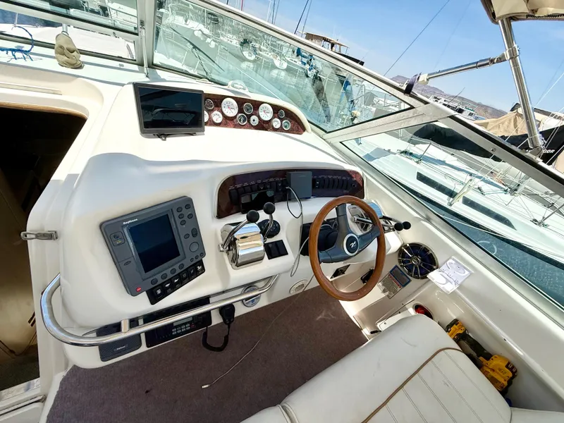 Slide: The Image of Cozy cabin interior of 1998 Sea Ray 330 Sundancer with plush bedding and mirror. - 11