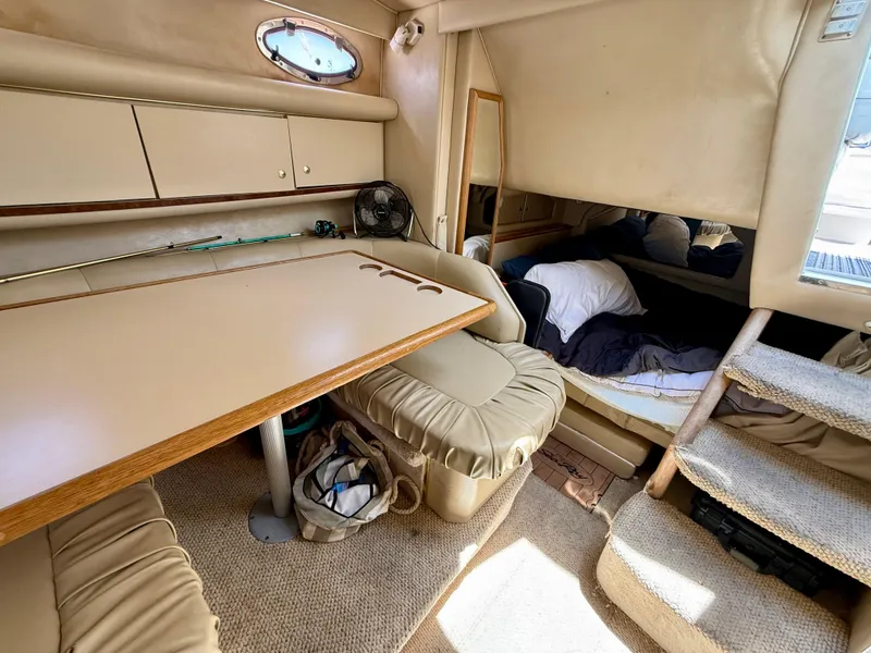 Slide: The Image of 1998 Sea Ray 330 Sundancer cabin interior with kitchenette, sink, and TV. - 12