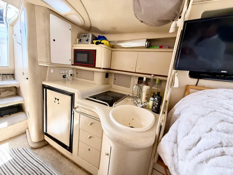 Slide: The Image of Engine compartment of a 1998 Sea Ray 330 Sundancer with V8 engine components. - 16