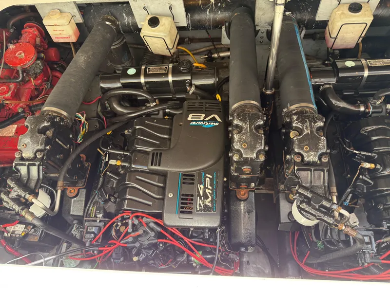 Slide: The Image of 1998 Sea Ray Sundancer 330 docked in a marina under a metal canopy. - 19