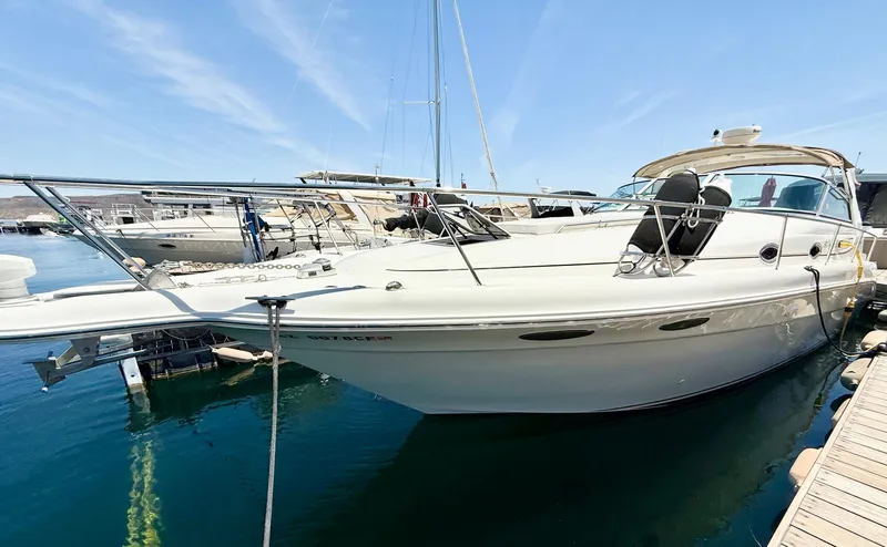 Slide: The Image of 1998 Sea Ray Sundancer 330 interior with seating, docked at marina. - 4