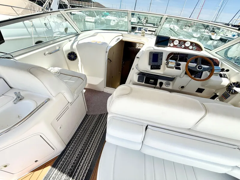 Slide: The Image of Interior of 1998 Sea Ray 330 Sundancer, featuring dining area and sleeping quarters. - 7