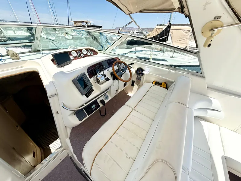 Slide: The Image of 1998 Sea Ray Sundancer 330 interior with white seating and wooden accents. - 8