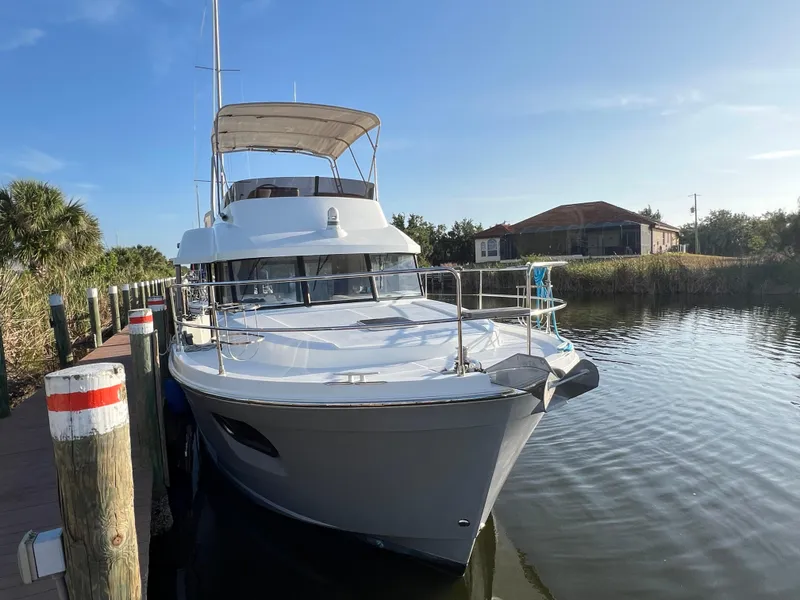 The Image of 2020 Beneteau Swift Trawler 35 docked by a serene waterfront. - 0