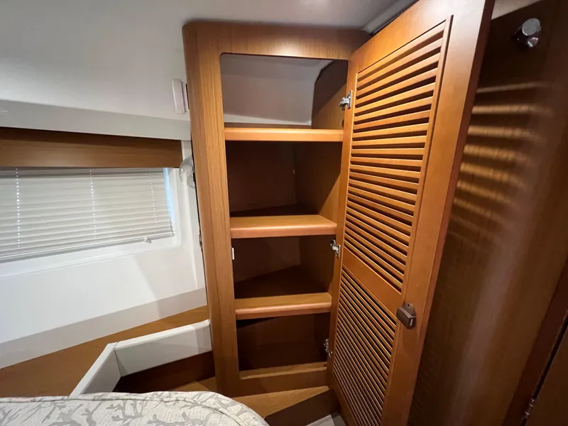 Slide: The Image of Interior of 2020 Beneteau Swift Trawler 35 with wooden shelves and window blinds. - 18