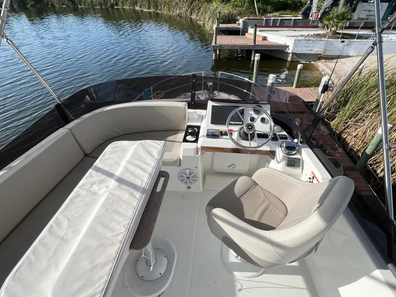 Slide: The Image of Beneteau Swift Trawler 35, 2020 model, featuring a spacious cockpit with seating and steering wheel. - 20