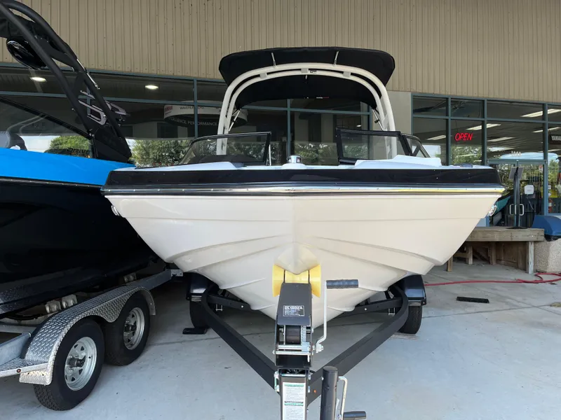 Slide: The Image of 2025 Yamaha Boats 195S on trailer, displayed outside a showroom. - 2