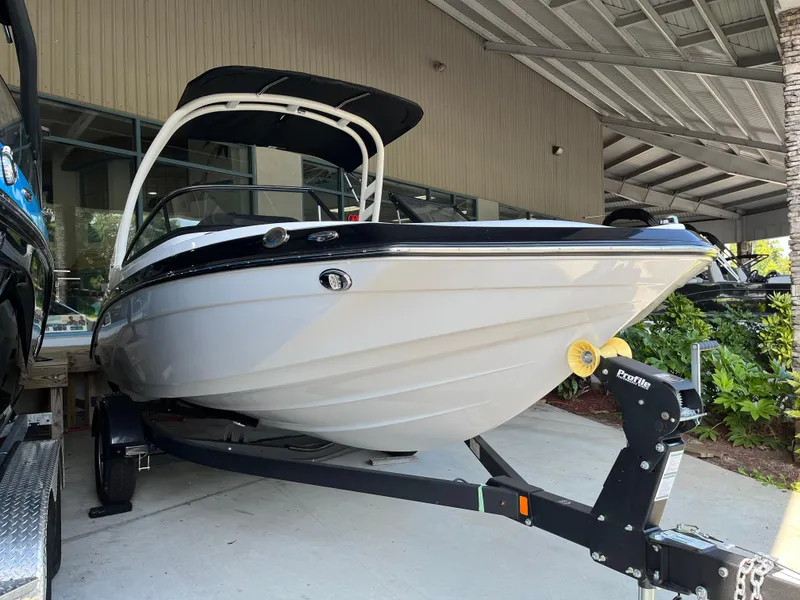 Slide: The Image of 2025 Yamaha Boats 195S on trailer, displayed in a covered showroom area. - 3