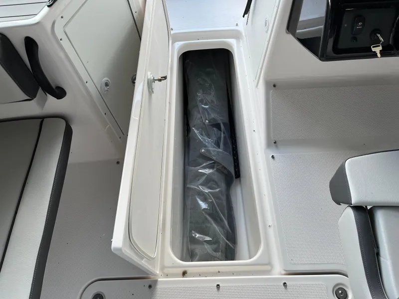 Slide: The Image of 2025 Yamaha AR190 boat storage compartment with open hatch, showcasing interior space. - 8