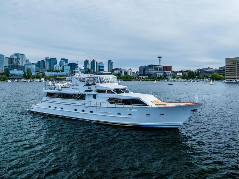 The Image of Luxurious 1991 Broward 102 yacht cruising on a scenic urban waterfront. - 0
