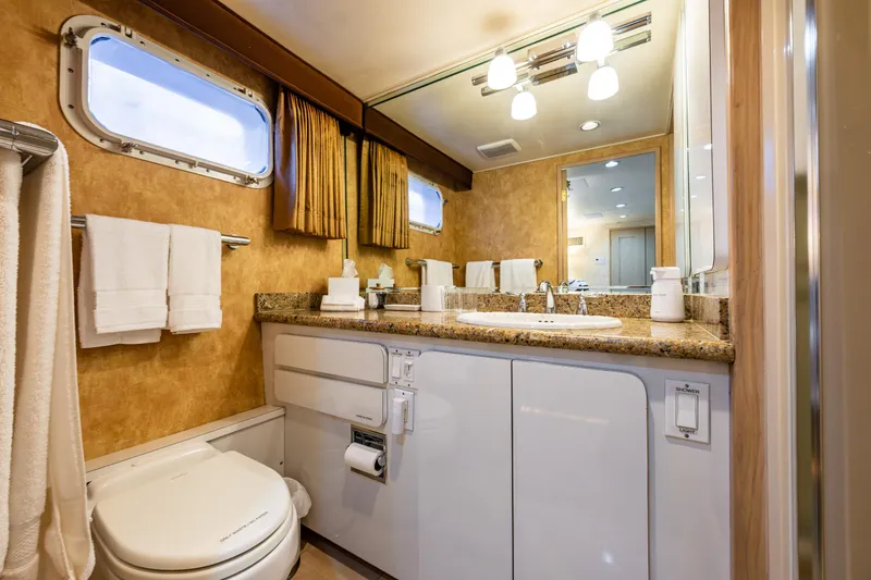 Slide: The Image of Luxurious bathroom in 1991 Broward 102 yacht with elegant fixtures and ample lighting. - 37