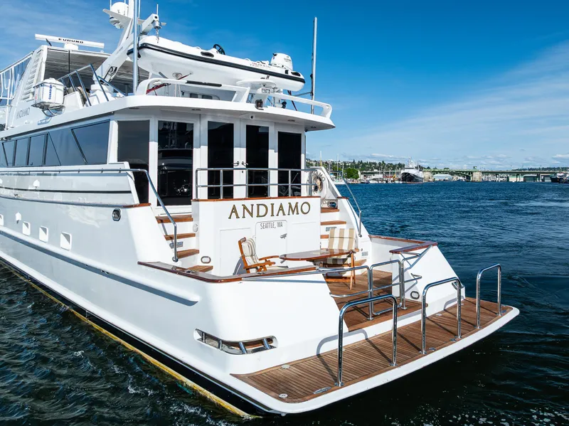 Slide: The Image of Luxury yacht Broward 102, 1991 model, named "Andiamo" on the water. - 4