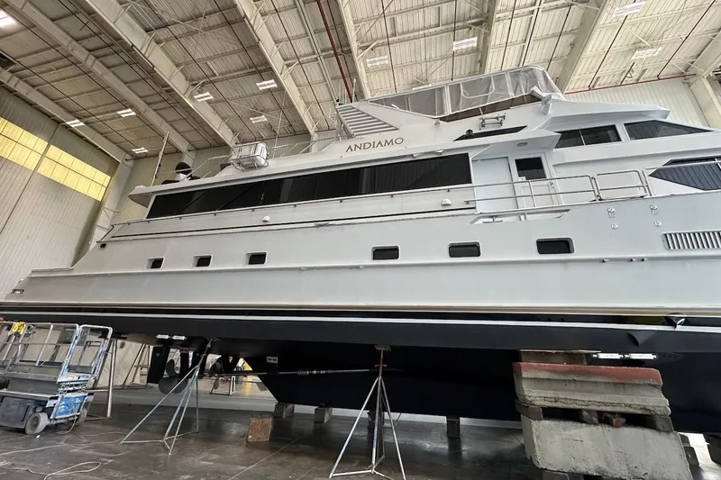 Slide: The Image of Large 1991 Broward 102 yacht in a shipyard for maintenance. - 86