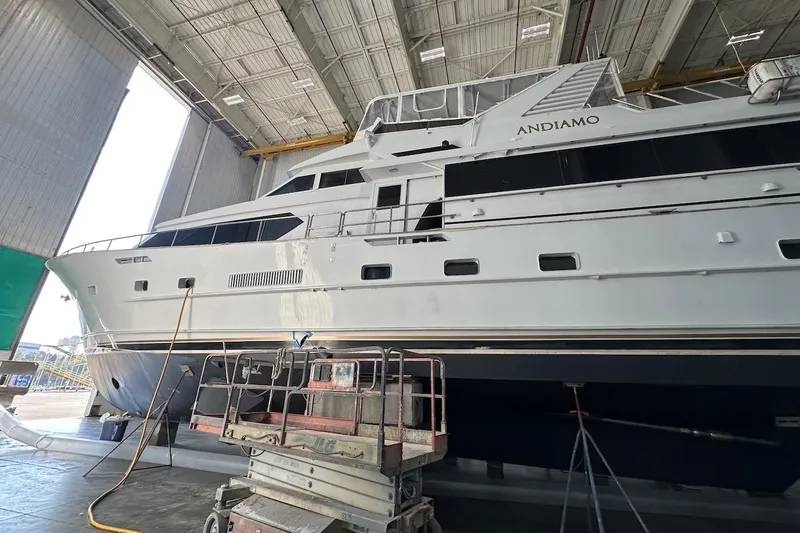 Slide: The Image of Luxury yacht Broward 102, 1991 model, in a shipyard for maintenance. - 88