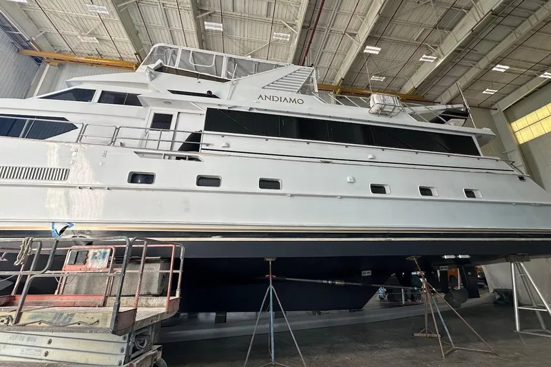 Slide: The Image of Luxury yacht Broward 102, 1991 model, in a shipyard for maintenance. - 89