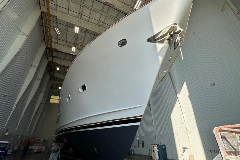Slide: The Image of Broward 102 yacht from 1991 in a large indoor facility, viewed from below. - 93
