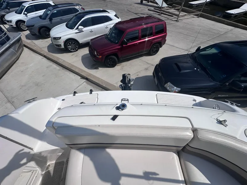 Slide: The Image of 1999 Chaparral 210 Sunesta boat interior with parked cars in the background. - 11