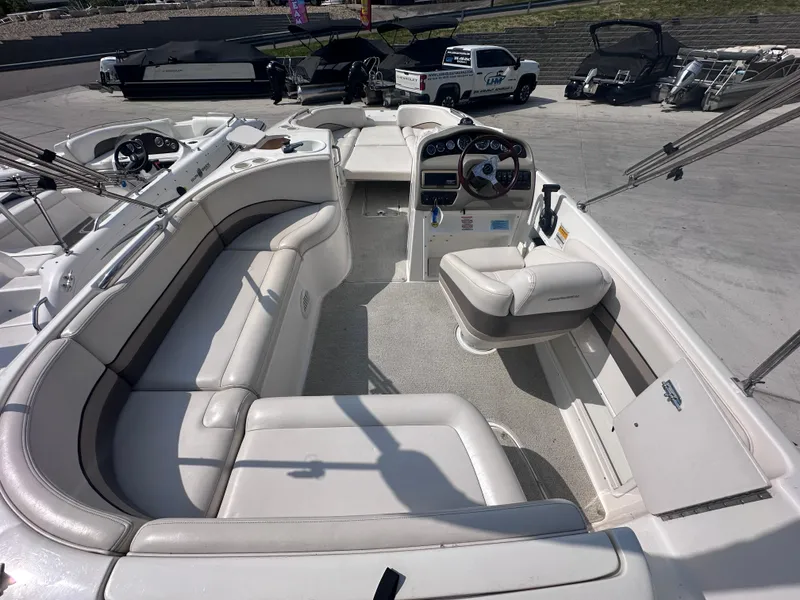 Slide: The Image of 1999 Chaparral 210 Sunesta boat interior with white seating and steering console. - 12