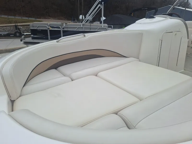 Slide: The Image of 1999 Chaparral 210 Sunesta boat interior with white cushioned seating. - 15