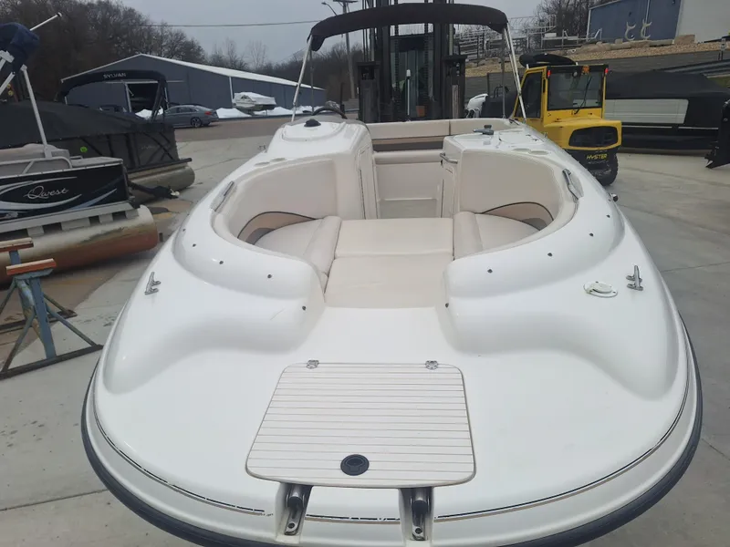 Slide: The Image of 1999 Chaparral 210 Sunesta boat with spacious seating, docked outdoors. - 16
