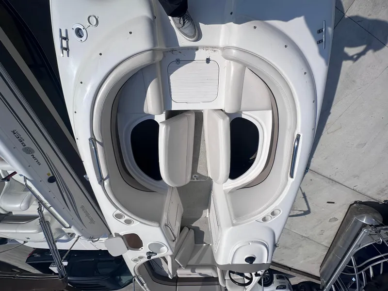 Slide: The Image of 1999 Chaparral 210 Sunesta boat interior with white seating and storage compartments. - 18