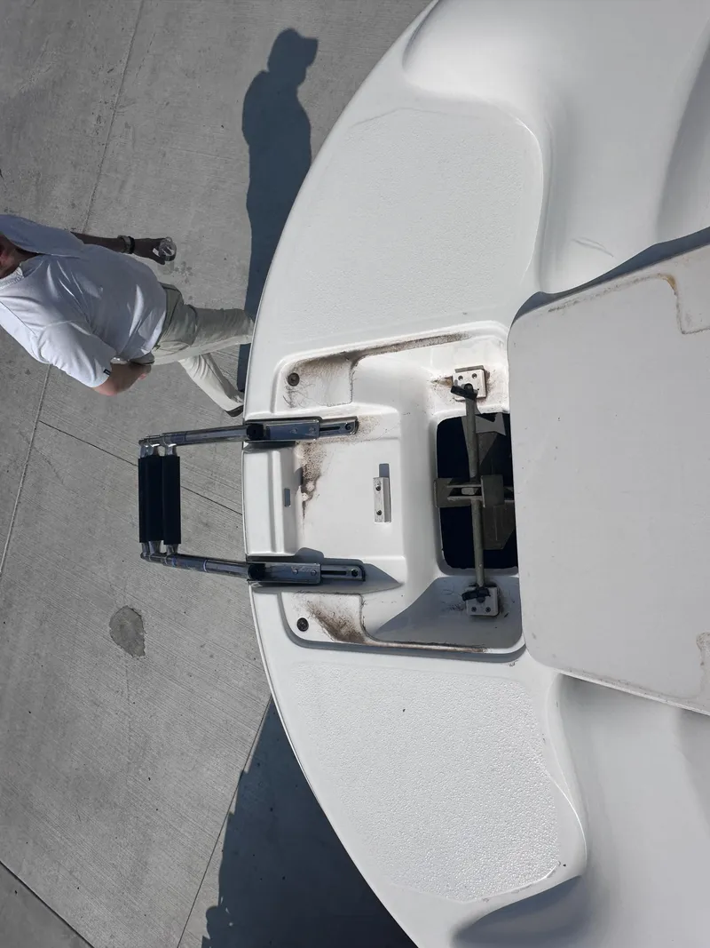 Slide: The Image of 1999 Chaparral 210 Sunesta boat with open hatch and ladder on deck. - 19