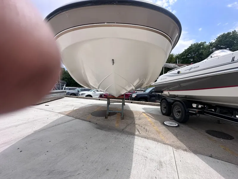 Slide: The Image of 1999 Chaparral 210 Sunesta boat on trailer, parked outdoors under a clear sky. - 2