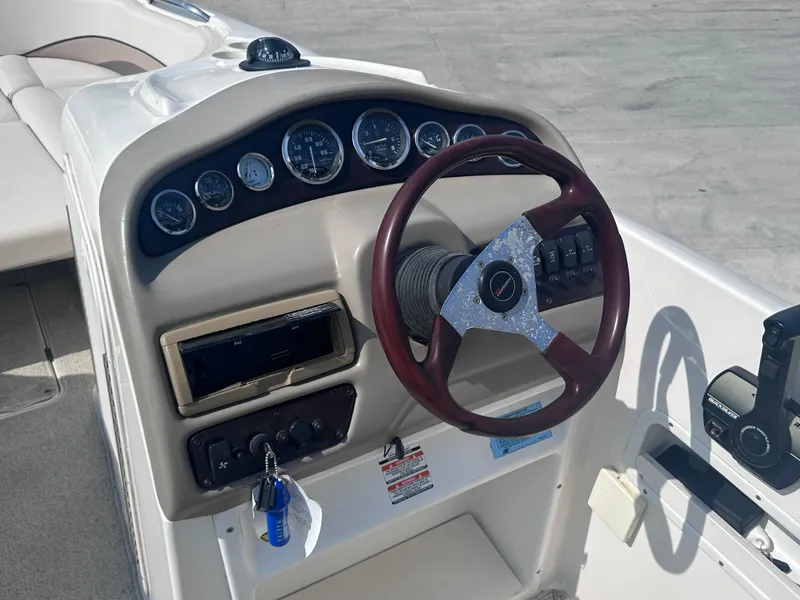 Slide: The Image of 1999 Chaparral 210 Sunesta boat dashboard with steering wheel and instrument panel. - 21