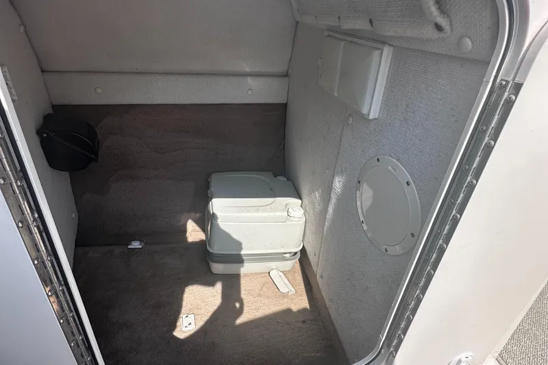Slide: The Image of Interior cabin of 1999 Chaparral 210 Sunesta boat with portable toilet. - 23