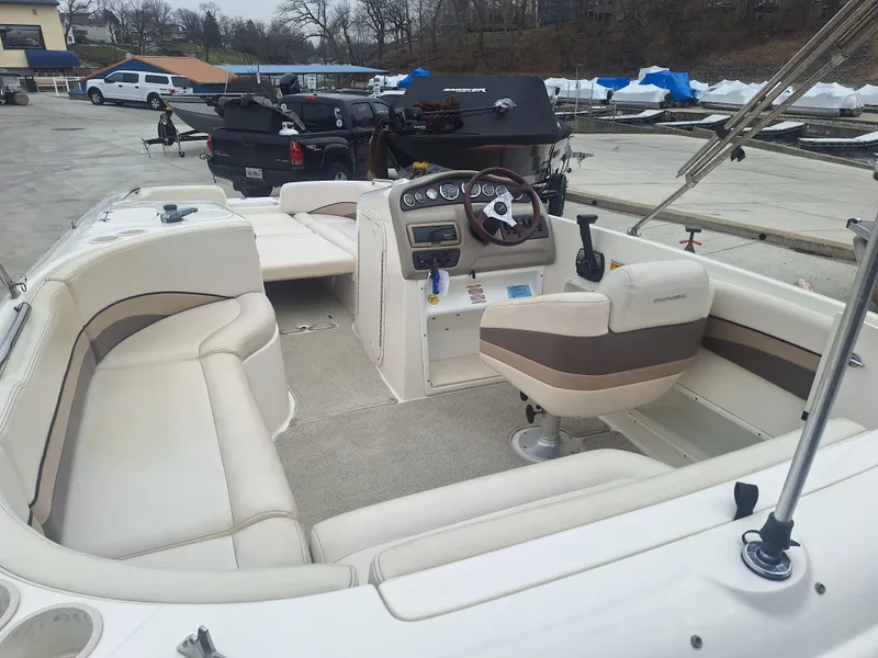 Slide: The Image of 1999 Chaparral 210 Sunesta boat interior with beige seating and steering console. - 25