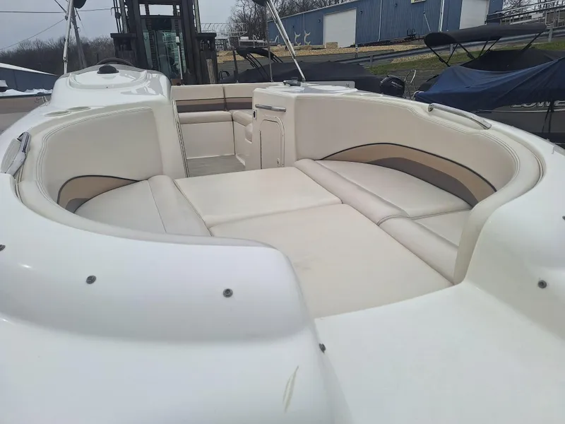 Slide: The Image of 1999 Chaparral 210 Sunesta boat interior with white seating and spacious layout. - 29