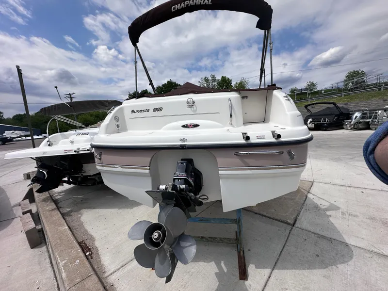 Slide: The Image of 1999 Chaparral 210 Sunesta boat, rear view, on a trailer, outdoors. - 3