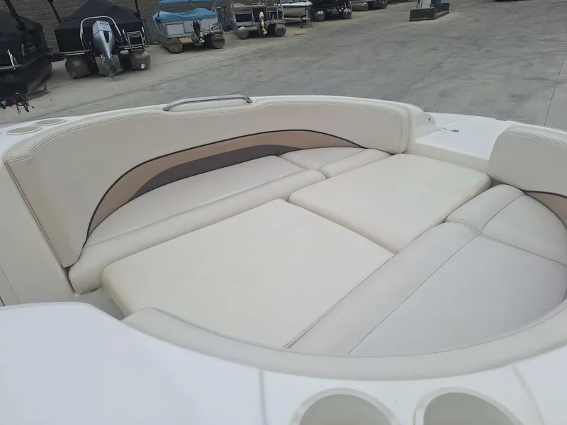 Slide: The Image of 1999 Chaparral 210 Sunesta boat interior with white cushioned seating. - 30