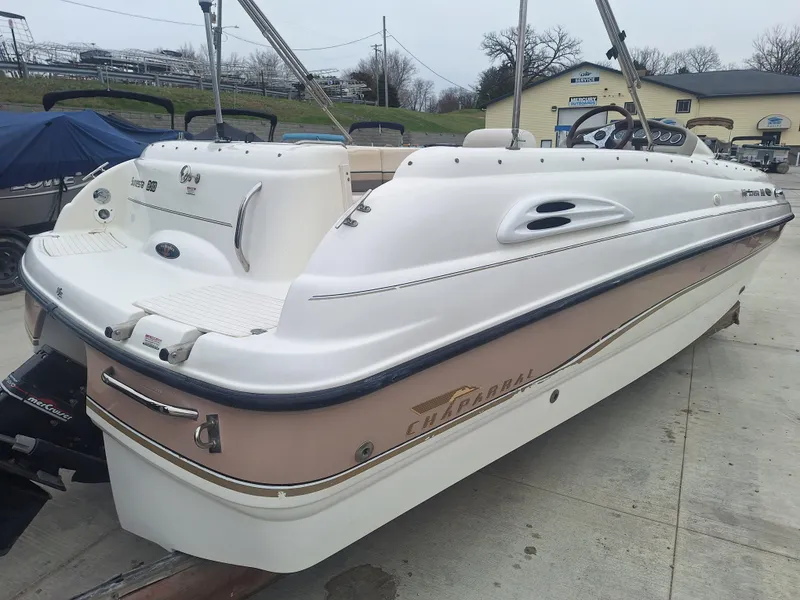 Slide: The Image of 1999 Chaparral 210 Sunesta boat on trailer, white and beige exterior, parked outdoors. - 31