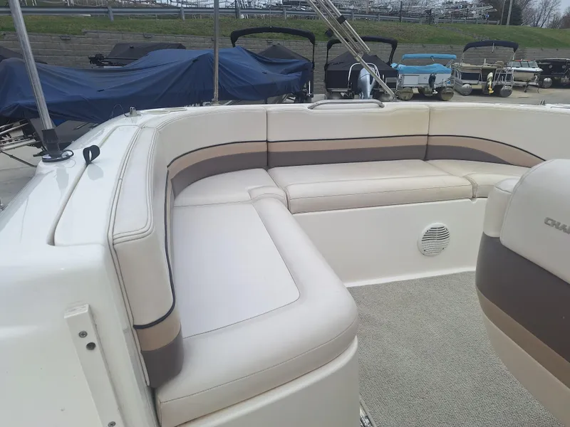 Slide: The Image of 1999 Chaparral 210 Sunesta boat interior with beige seating and carpeted floor. - 33
