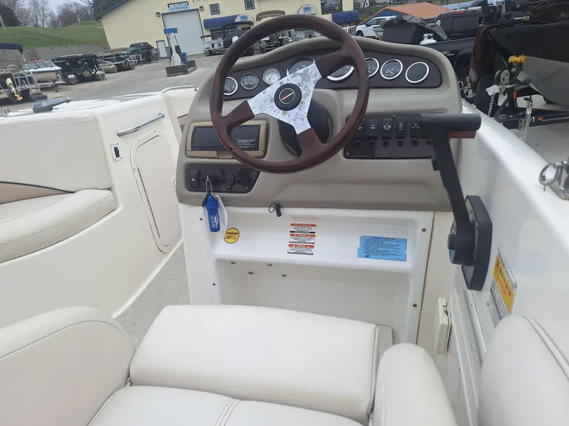Slide: The Image of 1999 Chaparral 210 Sunesta boat dashboard with steering wheel and control panel. - 34