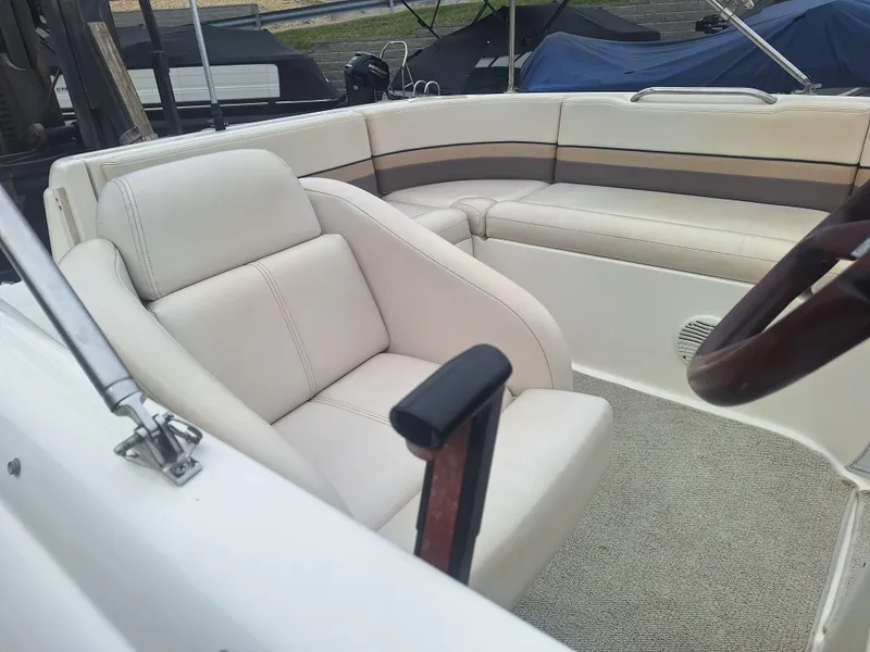 Slide: The Image of 1999 Chaparral 210 Sunesta boat interior with beige seating and carpeted floor. - 35
