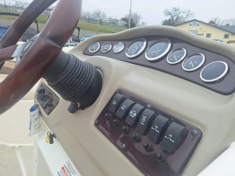 Slide: The Image of 1999 Chaparral 210 Sunesta dashboard with steering wheel and control panel. - 36