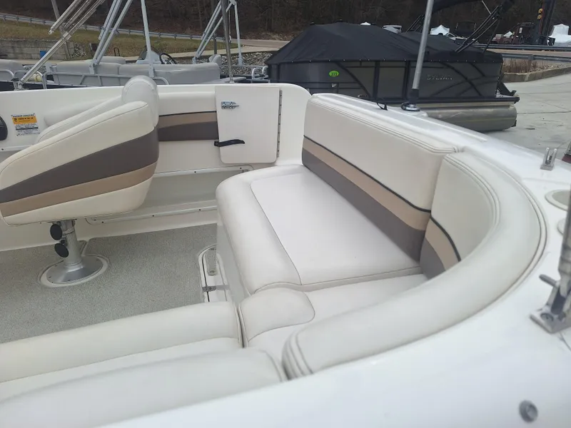 Slide: The Image of 1999 Chaparral 210 Sunesta boat interior with white and beige seating. - 37