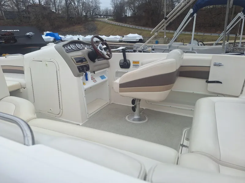 Slide: The Image of 1999 Chaparral 210 Sunesta boat interior with steering wheel and seating. - 38