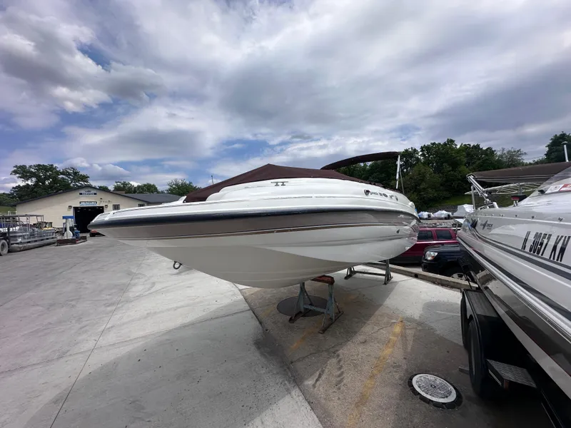 Slide: The Image of 1999 Chaparral 210 Sunesta boat on trailer under cloudy sky. - 4