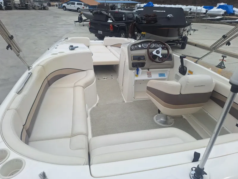 Slide: The Image of 1999 Chaparral 210 Sunesta boat interior with seating and steering console. - 40
