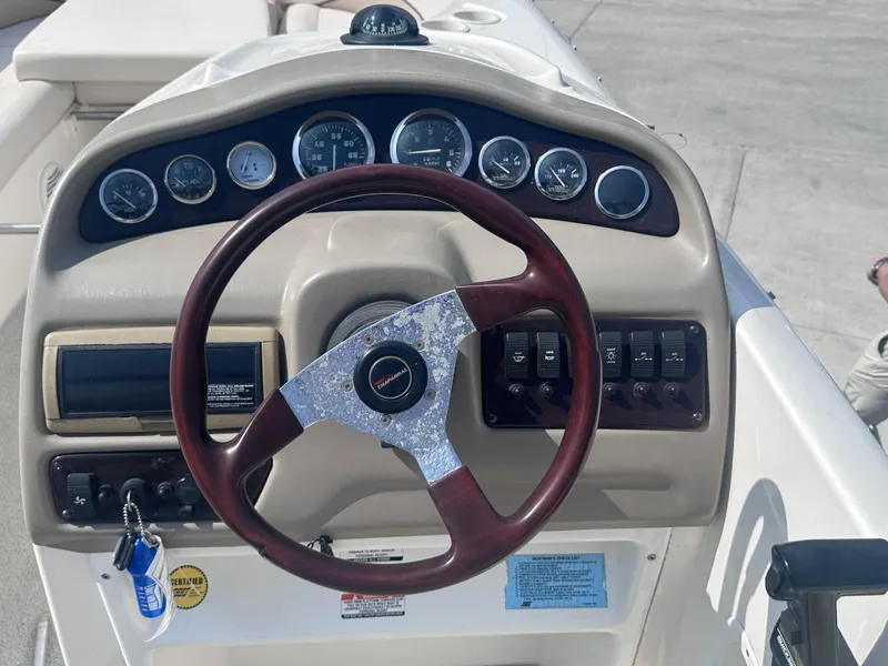 Slide: The Image of 1999 Chaparral 210 Sunesta boat dashboard with steering wheel and instrument panel. - 6