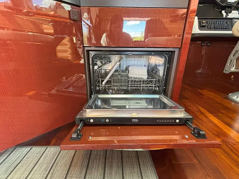 Slide: The Image of Built-in dishwasher on 2017 Sea Ray L590 yacht, open with visible interior. - 10