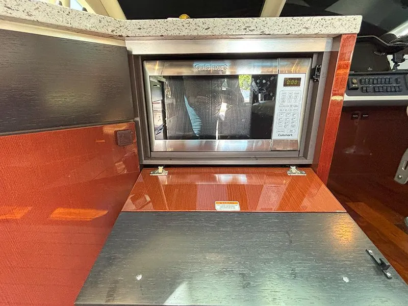 Slide: The Image of 2017 Sea Ray L590 yacht kitchen with built-in stainless steel microwave. - 11