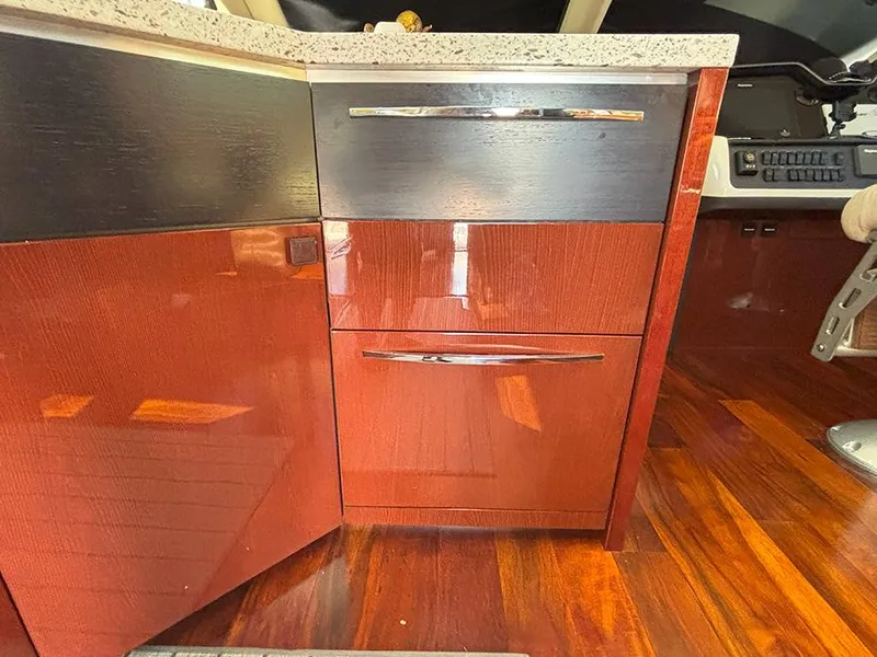 Slide: The Image of 2017 Sea Ray L590 yacht interior with sleek wooden cabinetry and polished flooring. - 12