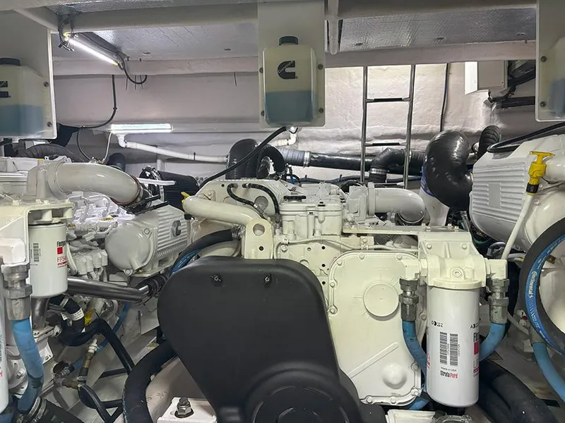 Slide: The Image of Engine room of a 2017 Sea Ray L590 yacht, showcasing mechanical components and piping. - 16