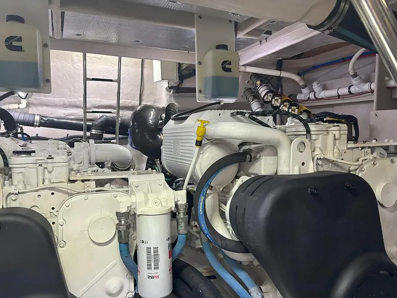 Slide: The Image of Engine room of 2017 Sea Ray L590 yacht, showcasing complex machinery and piping. - 17