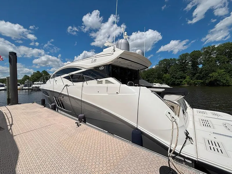 Slide: The Image of 2017 Sea Ray L590 yacht docked under a clear blue sky. - 2